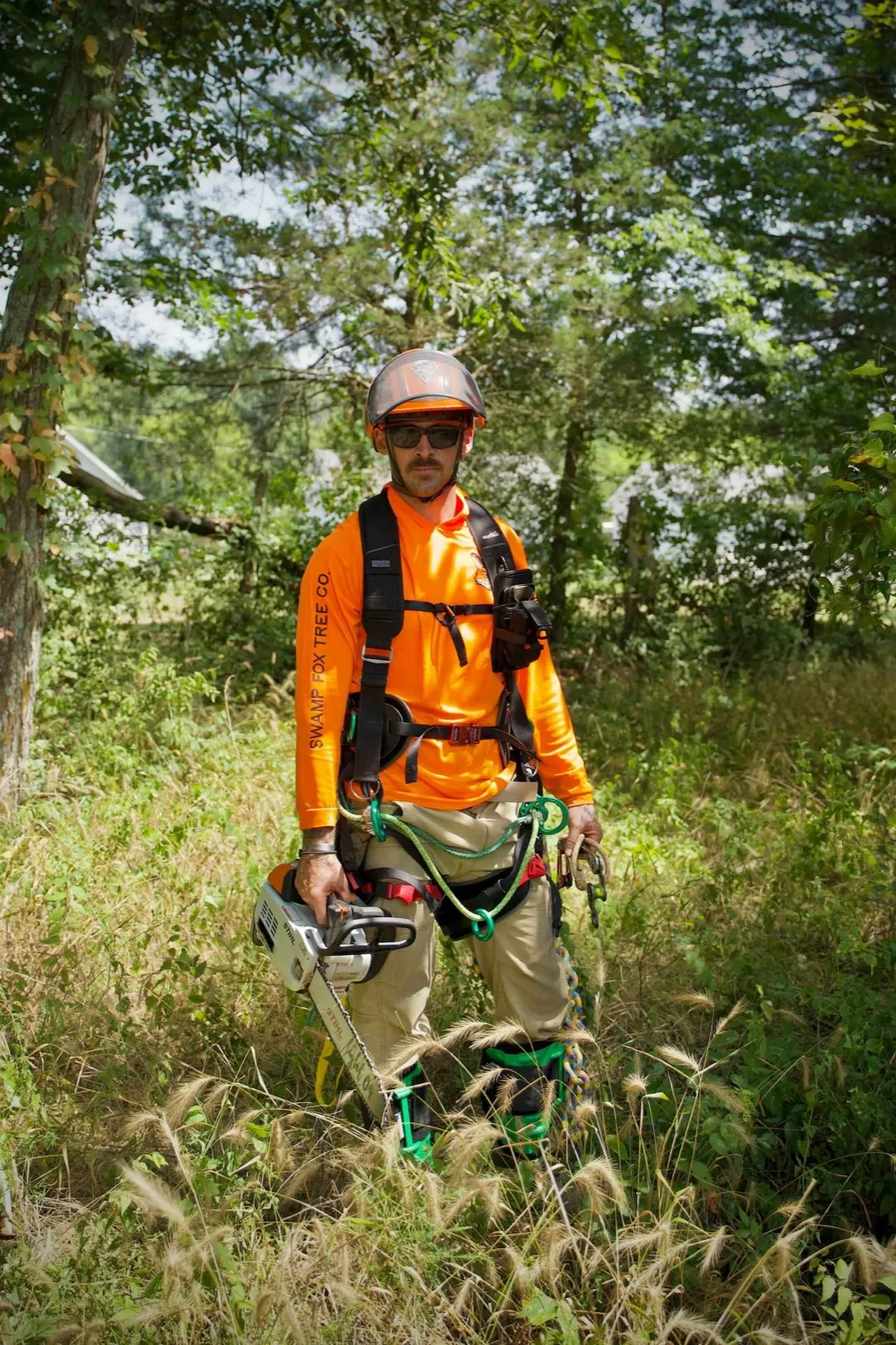 Swamp Fox Tree Co. climber in safety gear on a job site